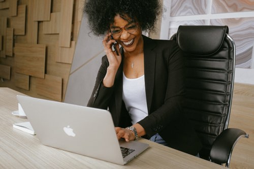 A HR professional using a mobile phone and laughing